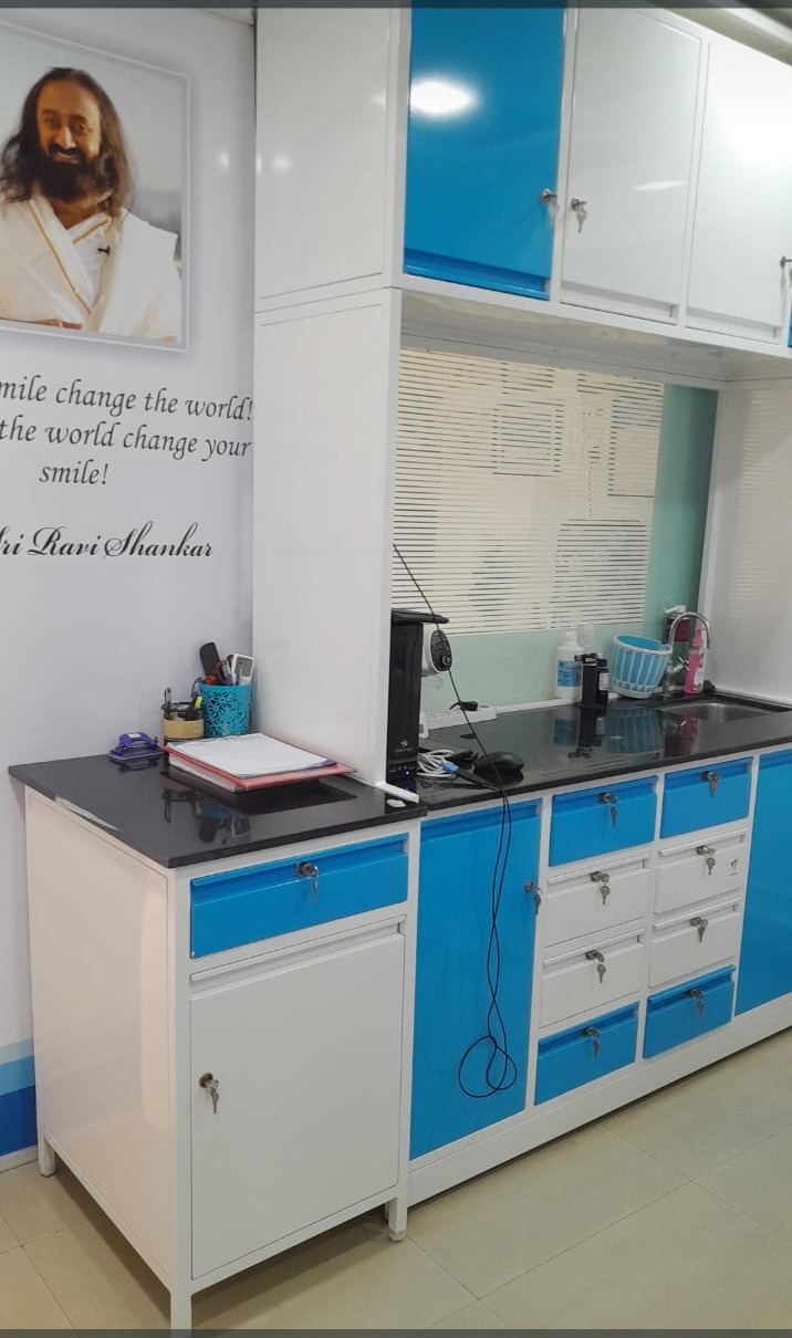 Sterilisation and instrument preparation area at Dr. Shweta's Dental Speciality Centre with blue and white cabinets and washing station